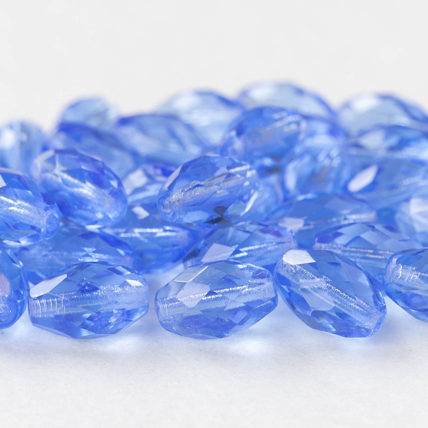 8x12mm Firepolished Glass Oval Beads - Light Sapphire Blue - 10 beads