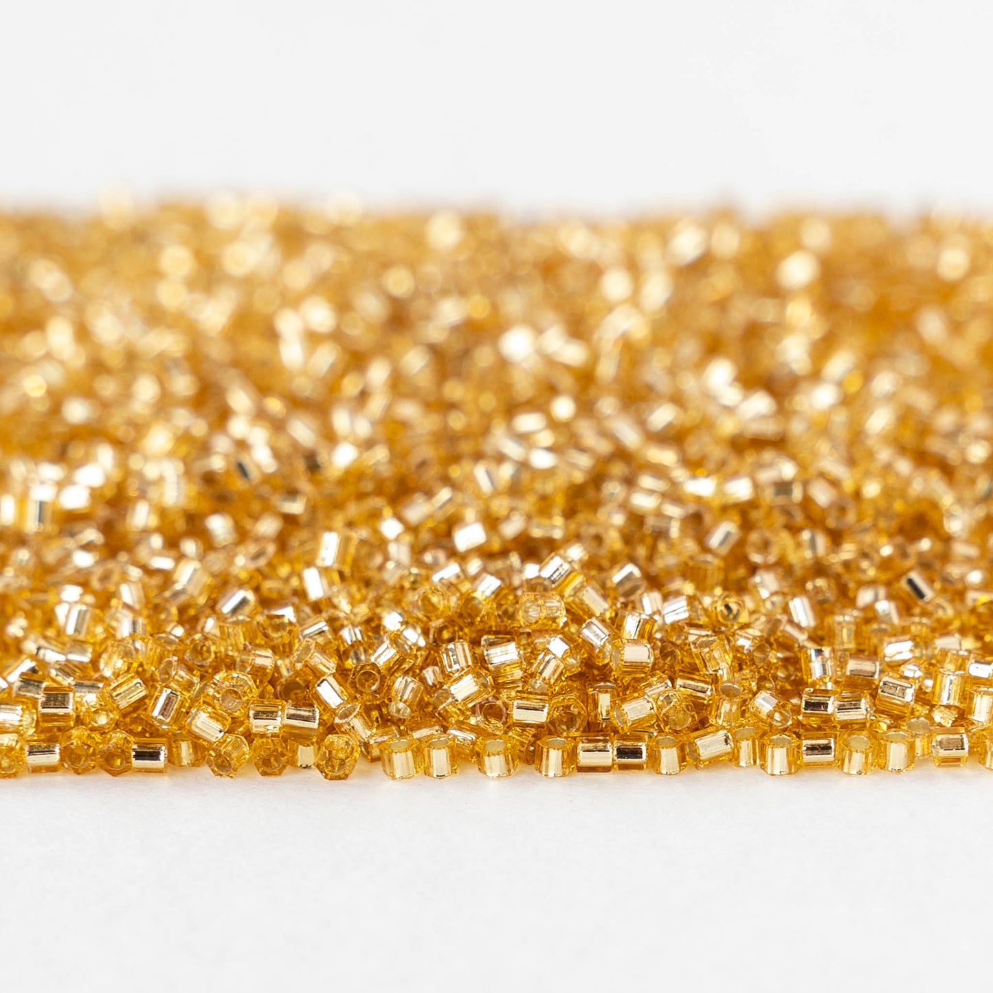 15/0 Glass Hex Cut Seed Beads - Silver Lined Topaz - 10 grams