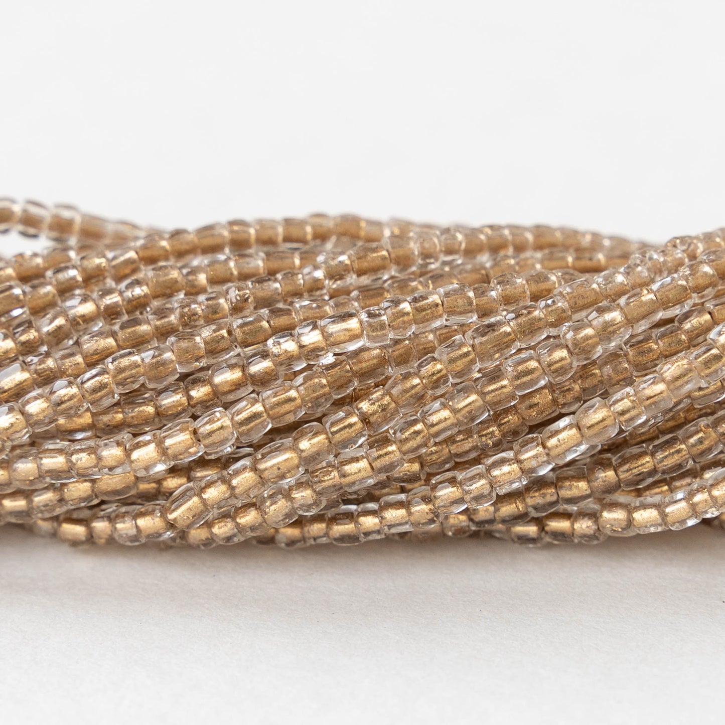 9/0 Seed Beads - Gold Lined Crystal - 18 inch strands - Whole or Half hank