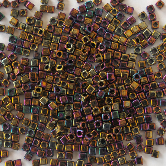 Load image into Gallery viewer, 1.8mm Miyuki Cube Beads  - Gold Iris - 10 grams
