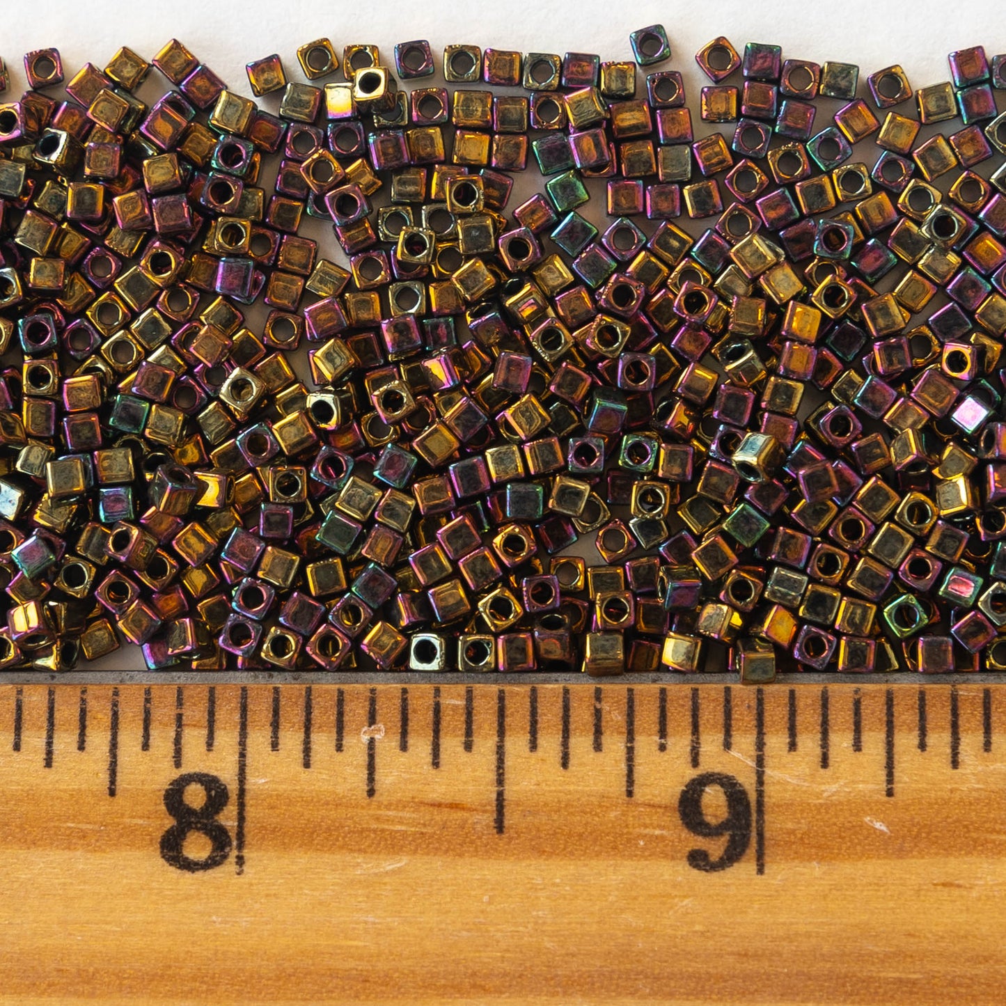 Load image into Gallery viewer, 1.8mm Miyuki Cube Beads  - Gold Iris - 10 grams
