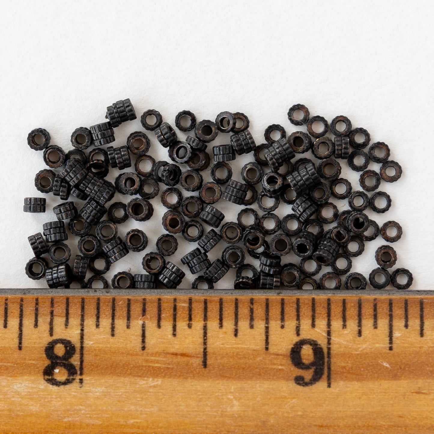 2.5mm Cog Spacer Beads - Black Brass - 3 Inches ` 100 Beads