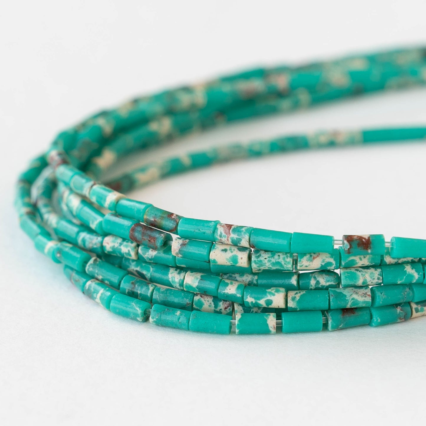 2.5x4mm Synthetic Impression Jasper Bugle Beads - Turquoise - 15 inch strand ~85 beads