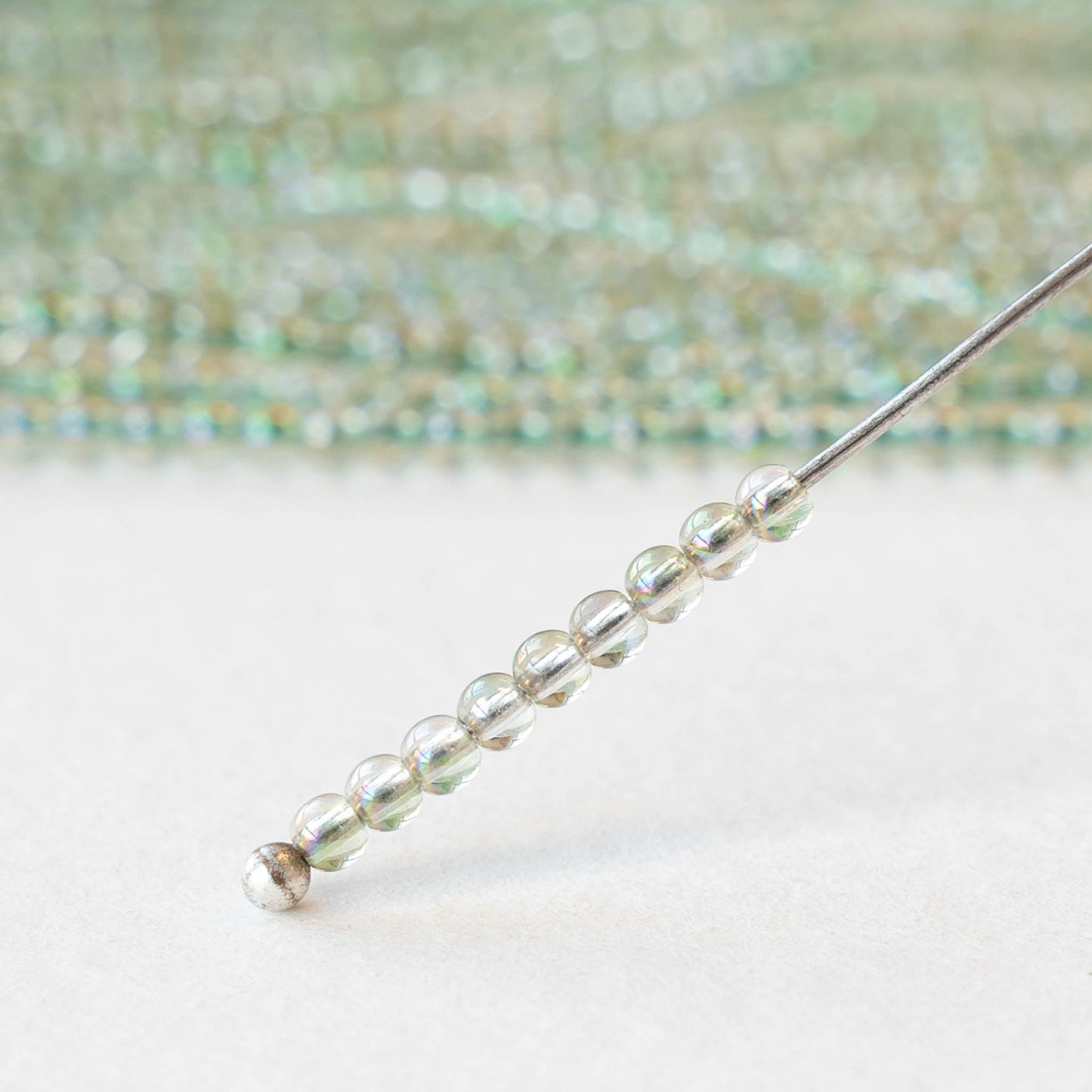 2mm Round Glass Beads - Crystal Green Luster - 15 inch strand ~200 beads