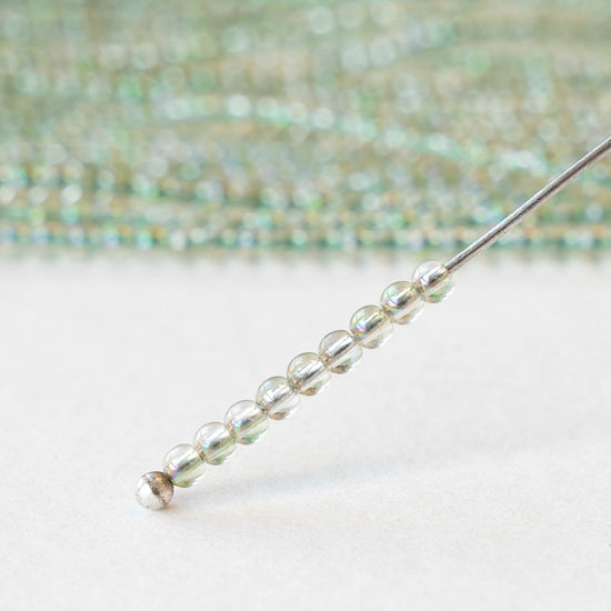 2mm Round Glass Beads - Crystal Green Luster - 15 inch strand ~200 beads