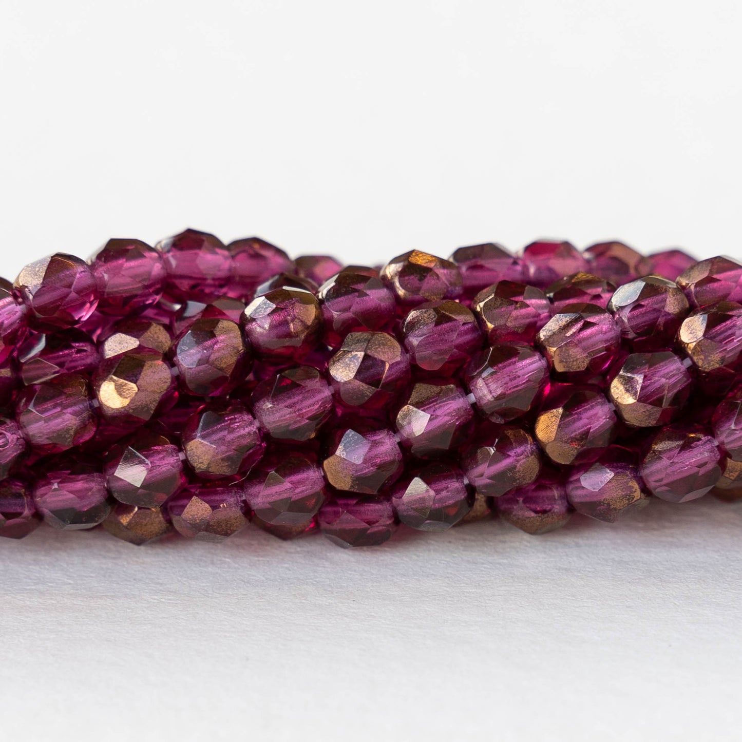 4mm Round Faceted Glass Beads - Transparent Raspberry Bronze Luster - 50 Beads