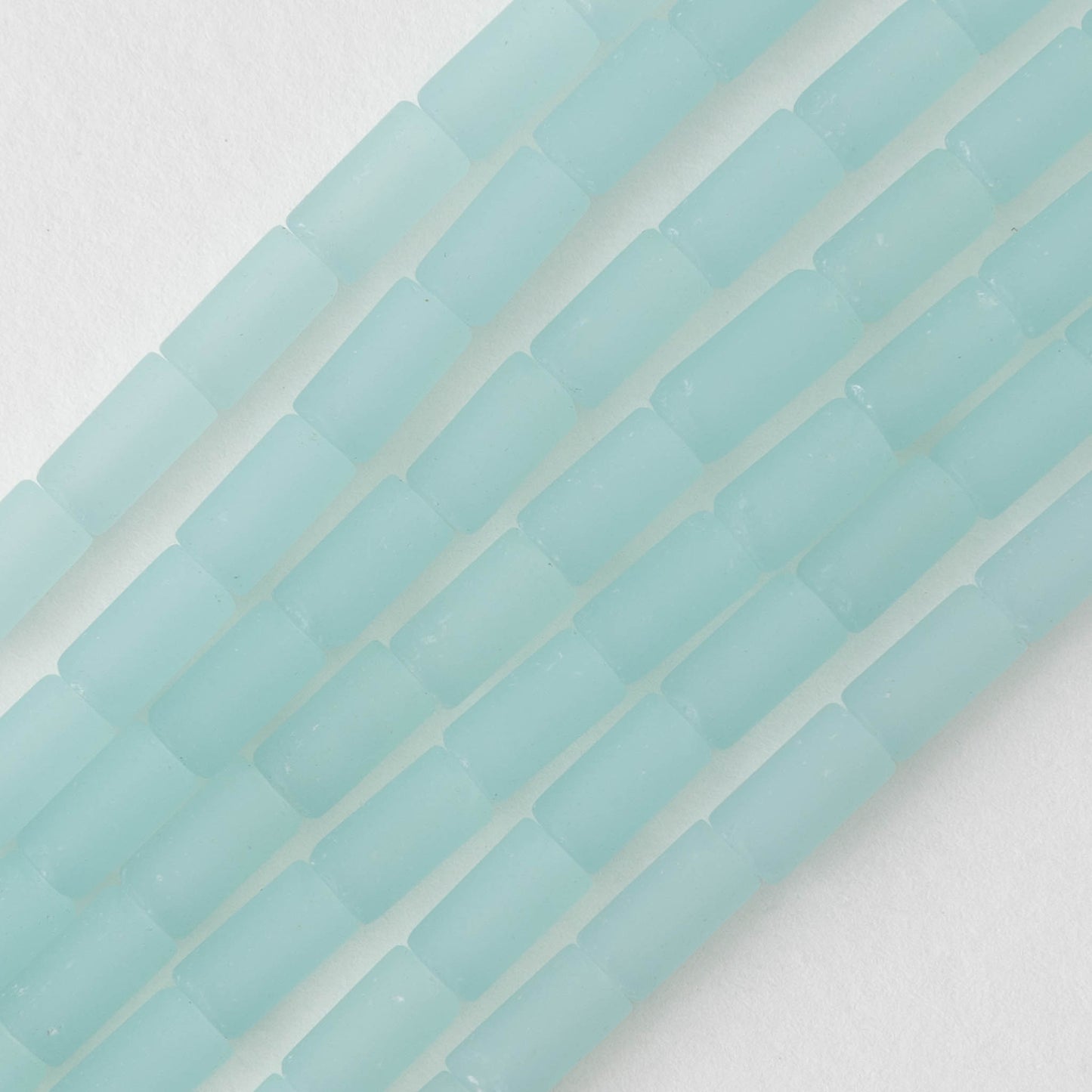 Load image into Gallery viewer, 4x9mm Frosted Glass Tube Beads - Very Light Blue - 46 tubes
