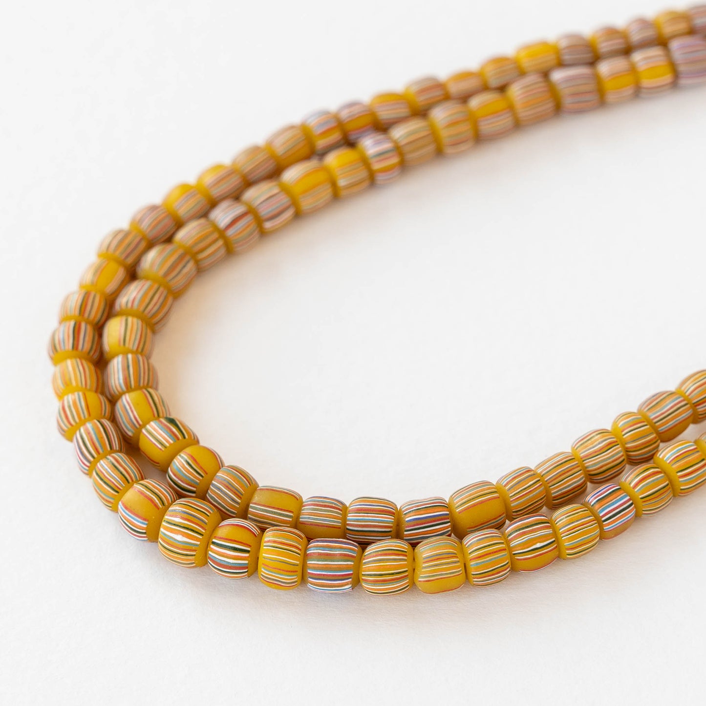 Glass Java Beads - Opaque Yellow with Colorful Stripes - Whole or Half Strand