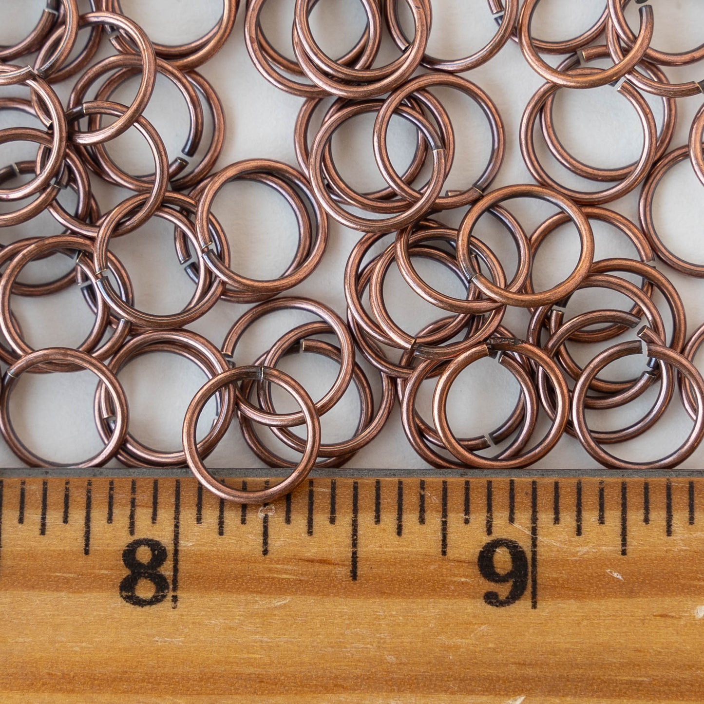 Load image into Gallery viewer, 8mm Jump ring - 18 Gauge - Antiqued Copper - 20 pieces
