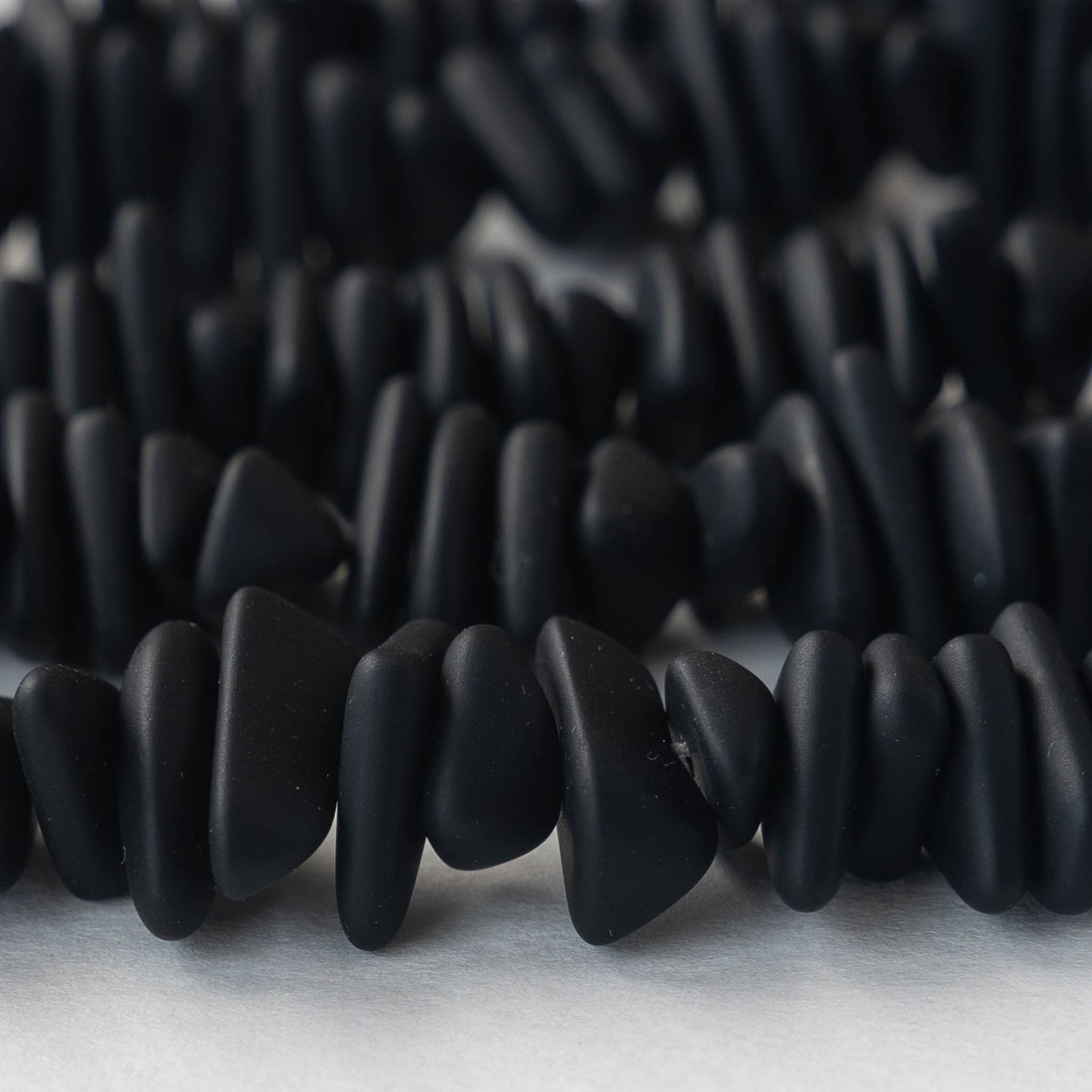 Load image into Gallery viewer, Frosted Glass Pebbles -Opaque Black - 50 Beads
