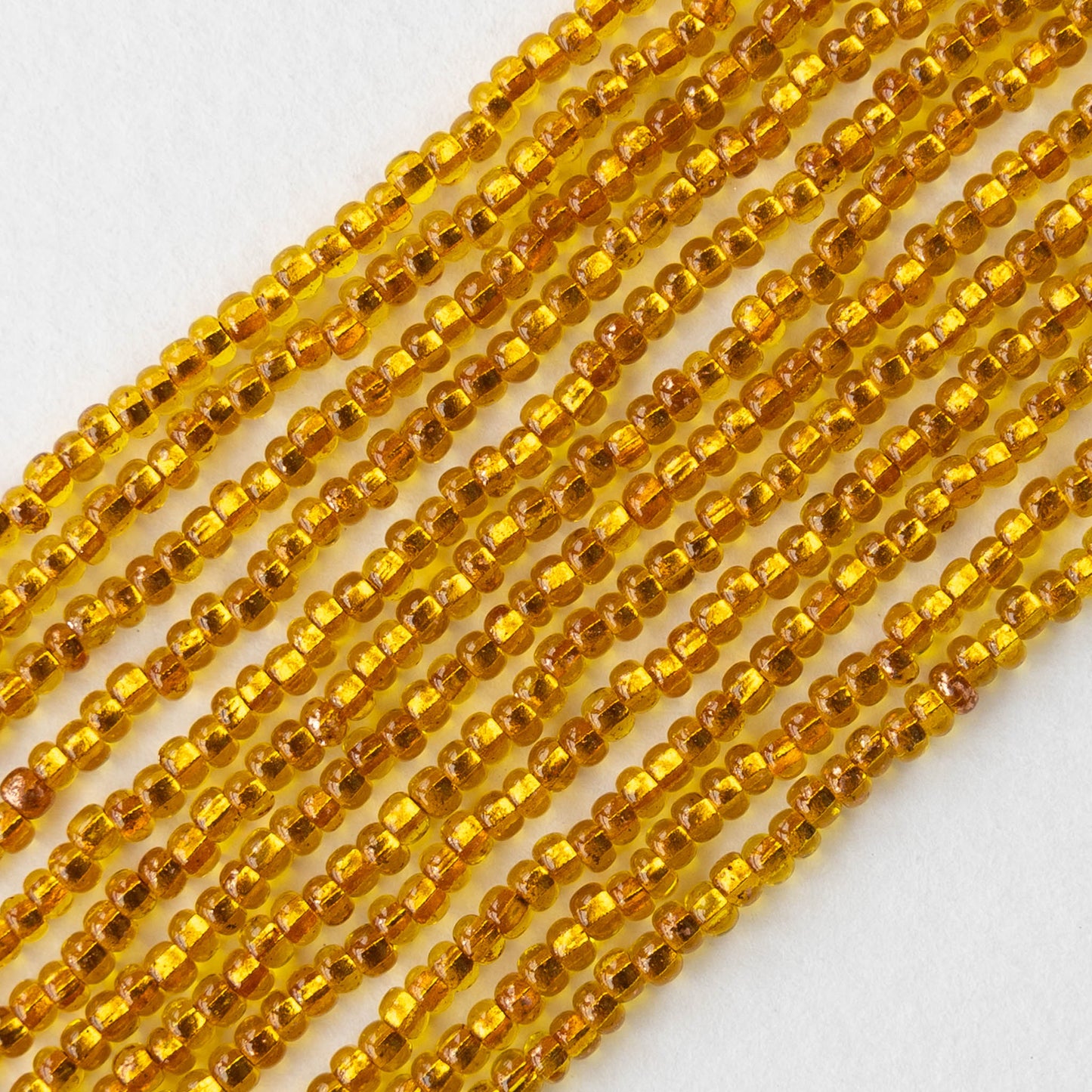 11/0 Glass Seed Beads - Copper Lined Citrine - 20 inch strands - Whole or Half hank