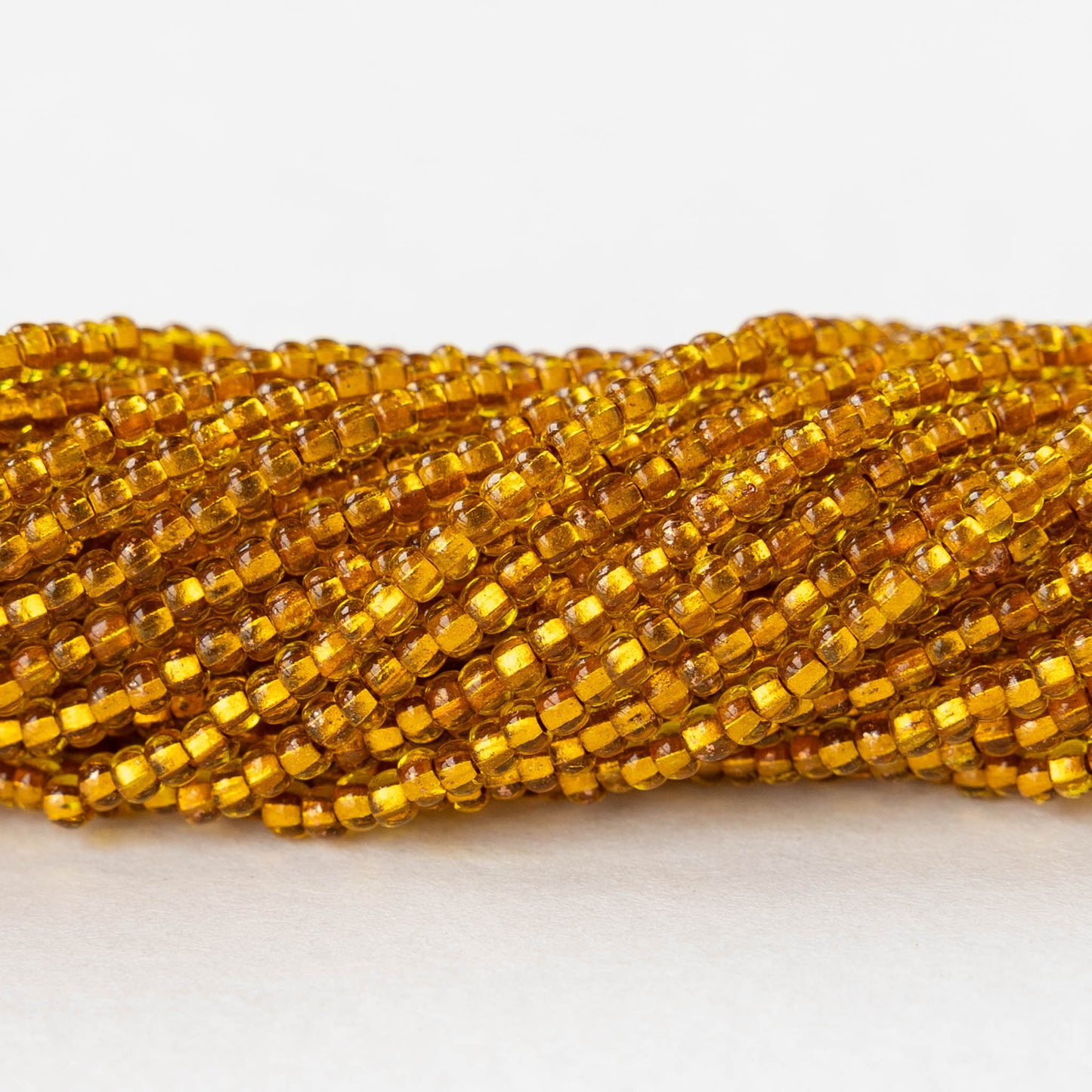 11/0 Glass Seed Beads - Copper Lined Citrine - 20 inch strands - Whole or Half hank