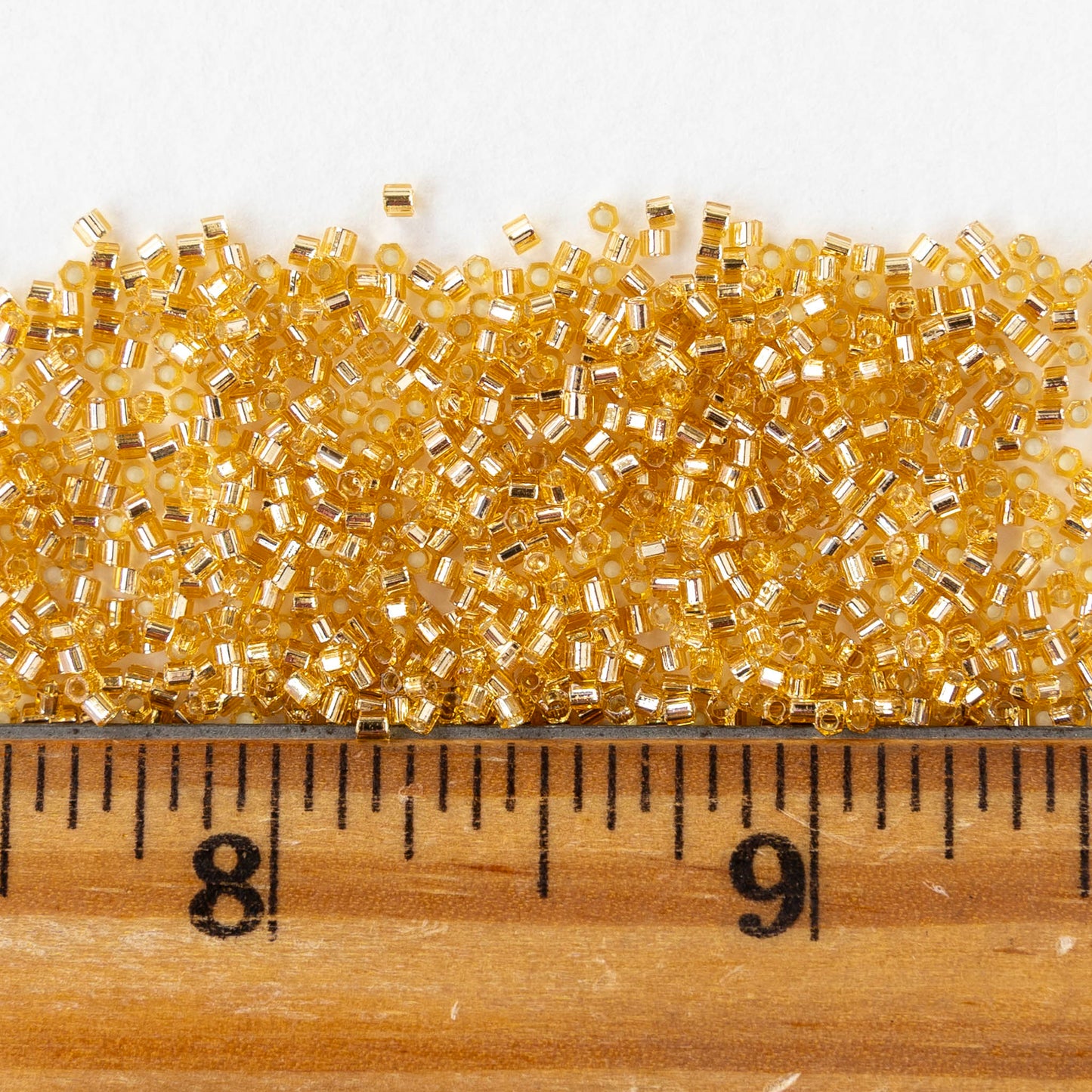 15/0 Glass Hex Cut Seed Beads - Silver Lined Topaz - 10 grams