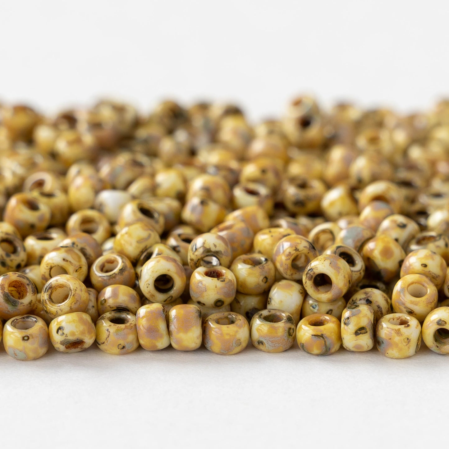 Size 6/0 Glass Seed Beads - Opaque Ivory Picasso - 10 grams ~135 beads