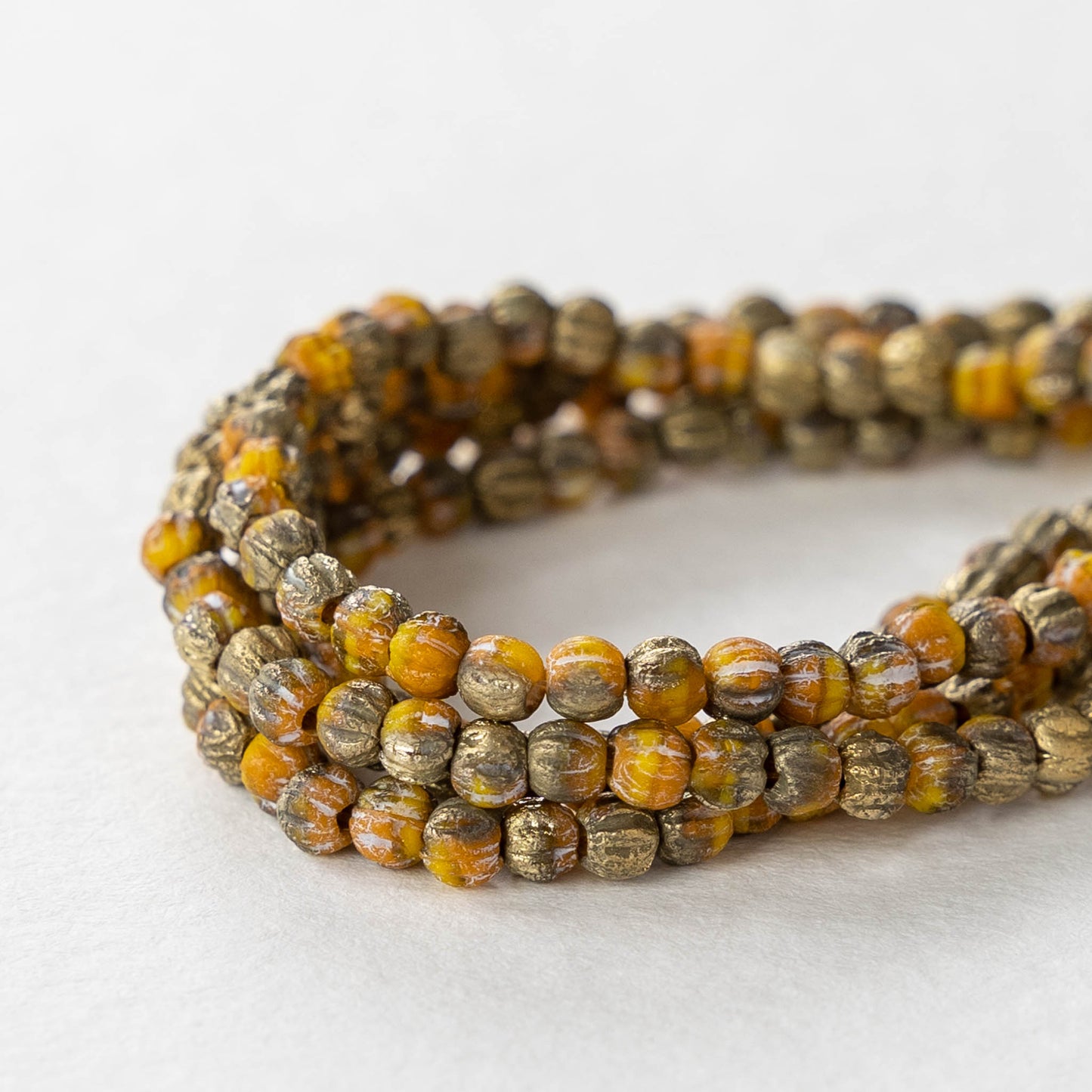 Load image into Gallery viewer, 3mm Melon Beads - Etched Orange Yellow with a Gold Finish - 50 Beads
