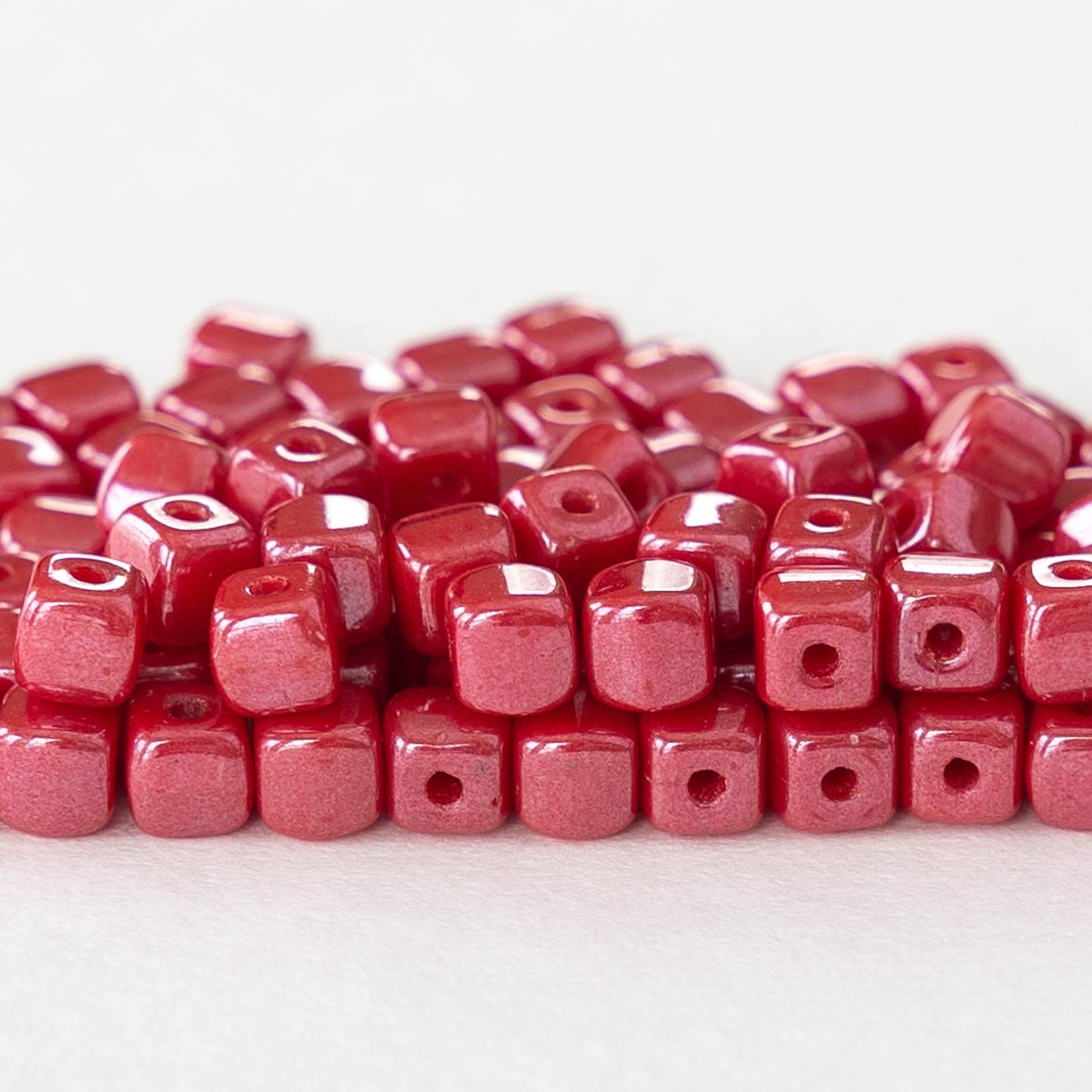 Load image into Gallery viewer, 4mm Glass Cube Beads - Opaque Red with Pink Luster - 100 beads
