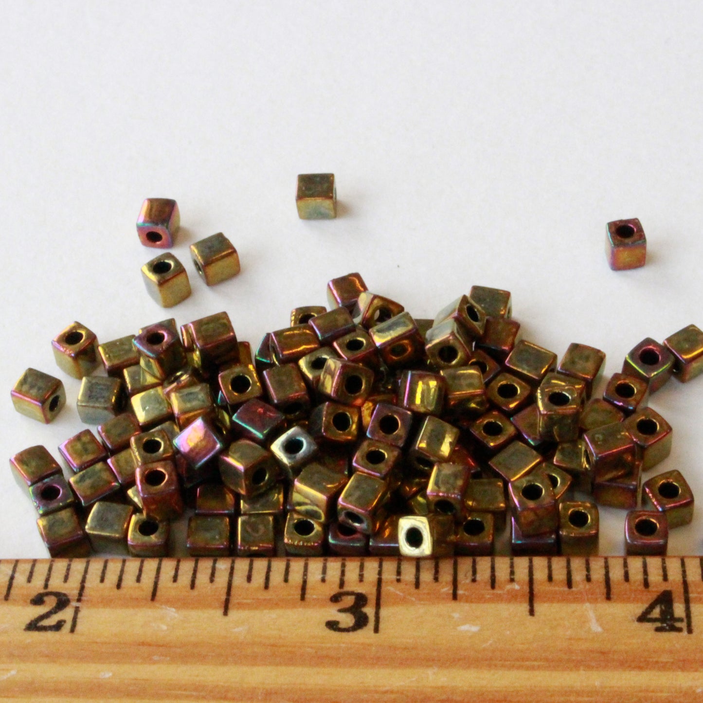 Load image into Gallery viewer, 4mm Miyuki Cube Beads - Metallic Gold Iris  Beads

