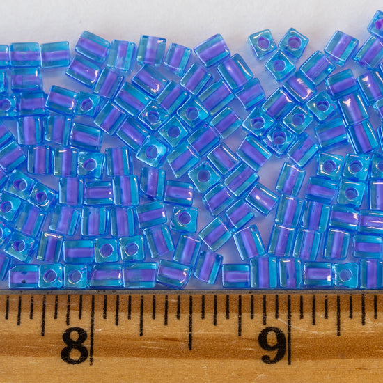 Load image into Gallery viewer, 4mm Miyuki Cube Beads  - Lavender Lined Sapphire Blue - 20 or 30 grams
