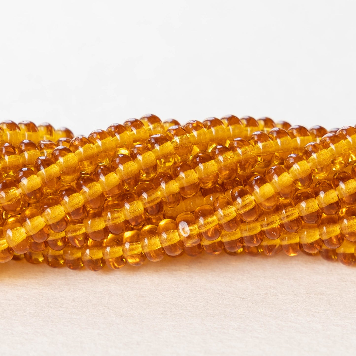 Load image into Gallery viewer, 4mm Rondelle Beads - Medium  Amber Topaz - 100 beads
