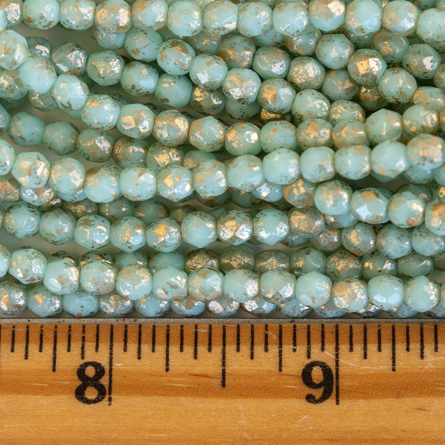 Load image into Gallery viewer, 4mm Round Firepolished Beads -  Mint with Gold Finish - 50 Beads
