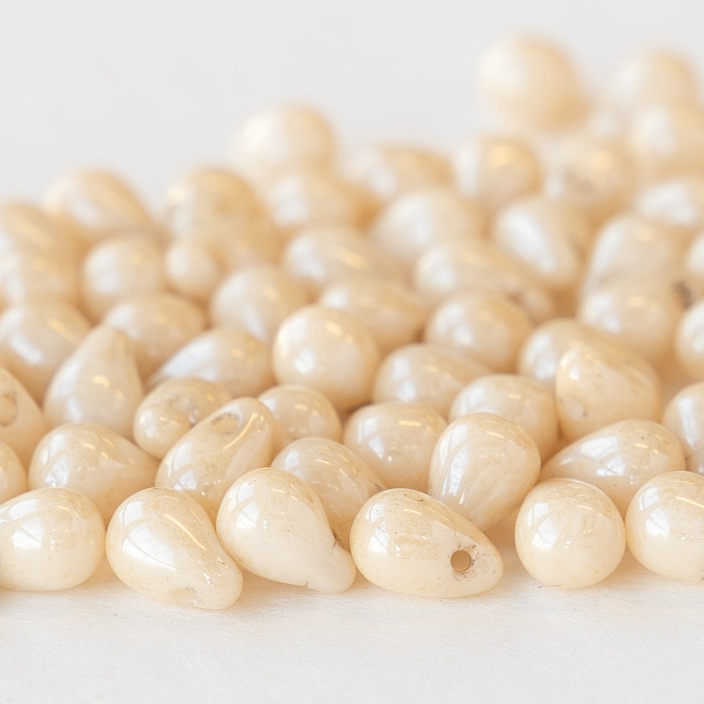 Load image into Gallery viewer, 4x6mm Glass Teardrop Beads - Ivory Luster - 13 grams ~ 100 beads
