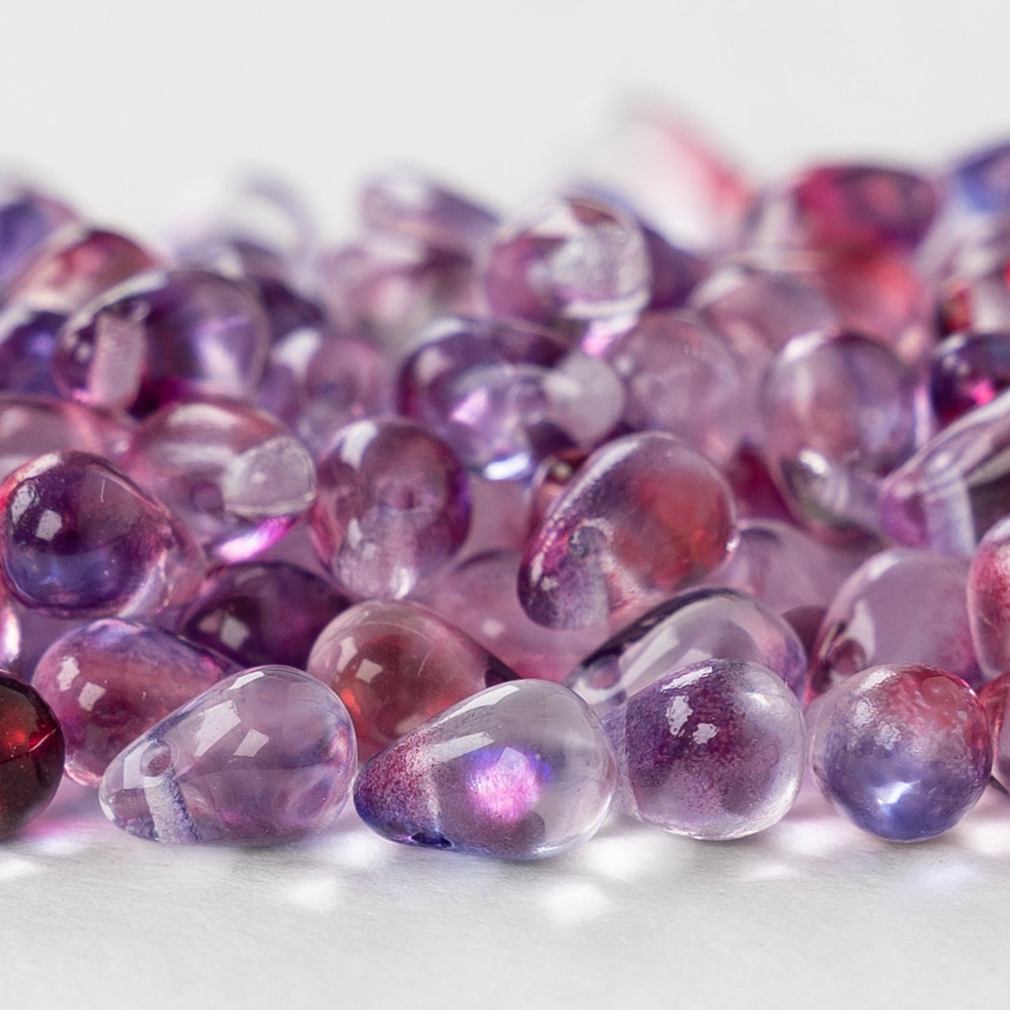 Load image into Gallery viewer, 5x7mm Glass Teardrop Beads - Transparent Purple Pink Mix - 75 beads
