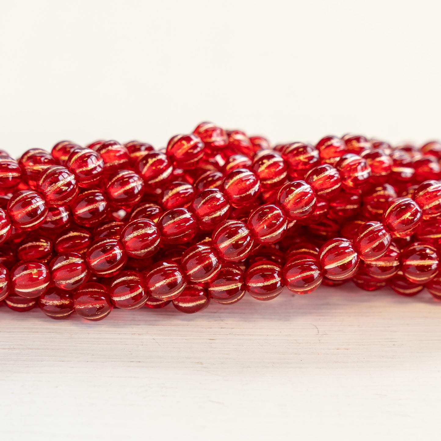 Load image into Gallery viewer, 5mm Melon Beads - Red with Gold Wash - 50 Beads
