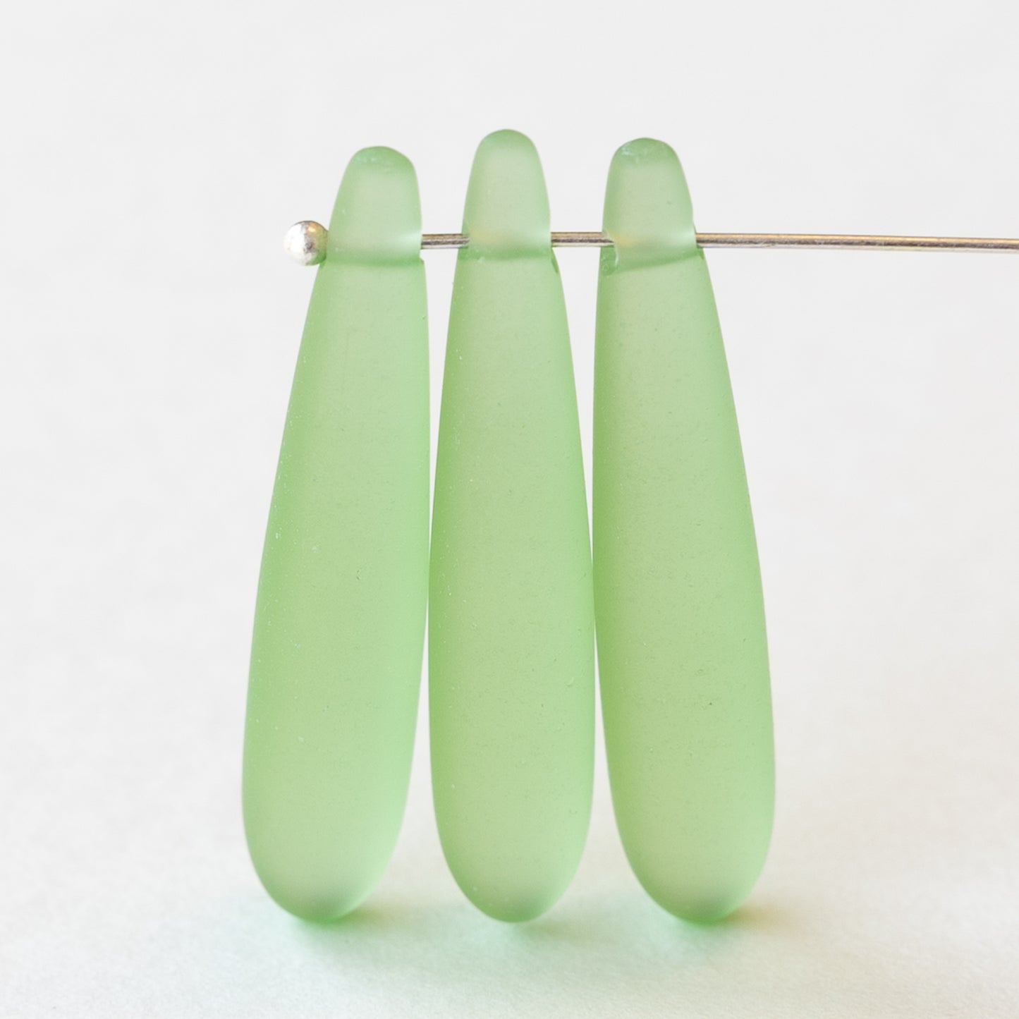 Load image into Gallery viewer, 8x37mm Frosted Glass Top Drilled Drops - Summer Green - 4 Beads

