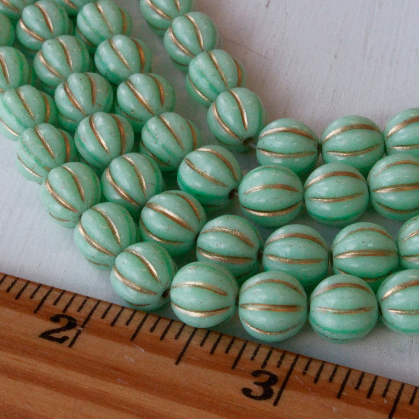 Load image into Gallery viewer, 10mm Melon Beads - Green Mint with Gold Wash - 15 Beads

