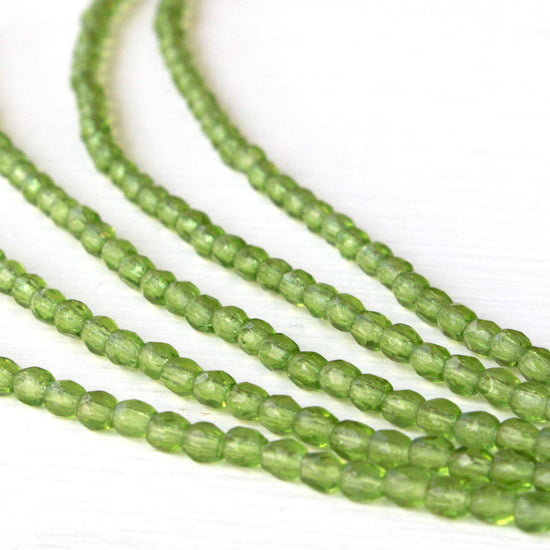Load image into Gallery viewer, 3mm Round Glass Beads - Transparent Olivine - 80 Beads

