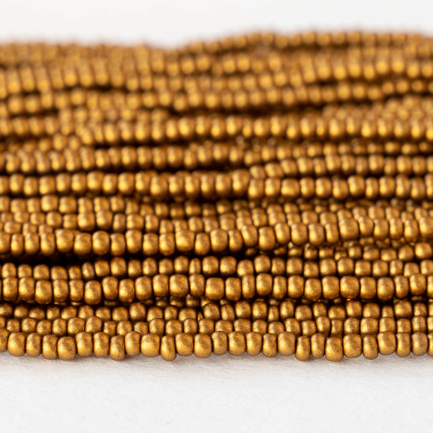 Load image into Gallery viewer, 11/0 Glass Seed Beads - Antique Matte Gold - 6 Strands
